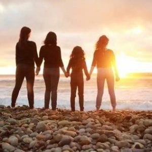 Women at beach at sunset - surviving divorce- Silver Linings Transitions